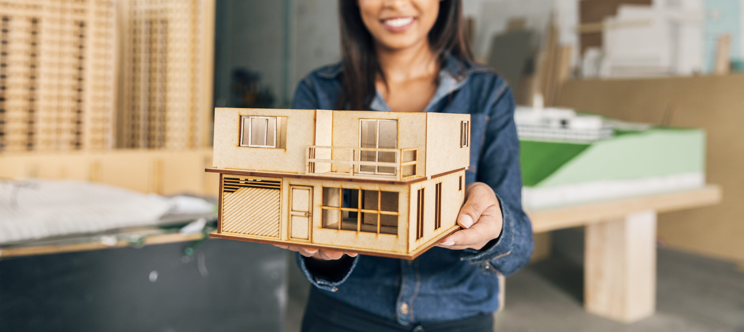 smiling-african-american-woman-showing-model-house